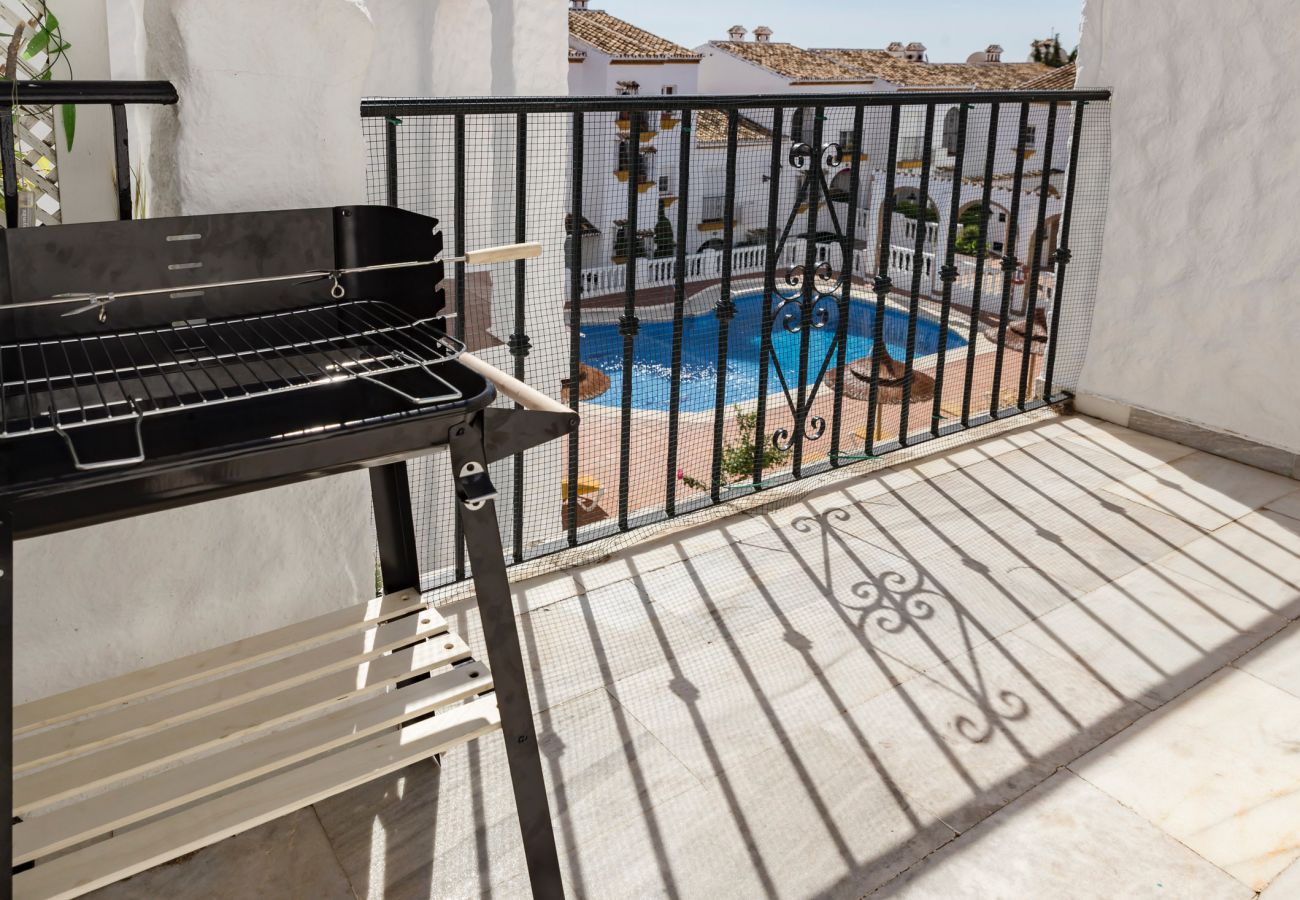 Terraza con barbacoa y vistas a la piscina